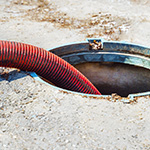 septic system hose inside of septic tank in the ground